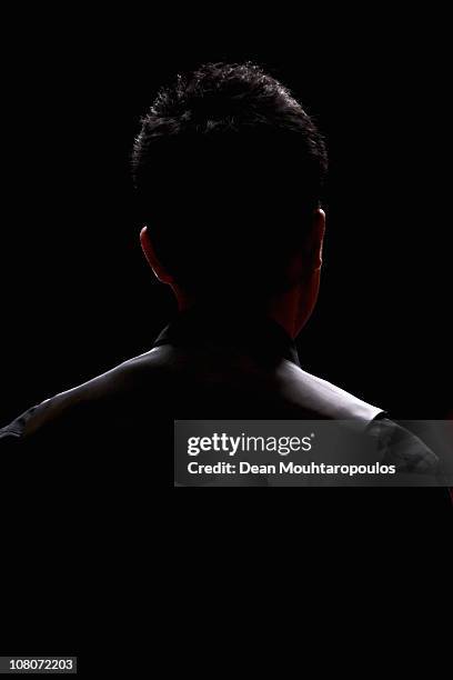 Marco Fu of Hong Kong watches Ding Junhui of China in the Final of The Ladbrokesmobile Masters on Day 8 at Wembley Arena on January 16, 2011 in...