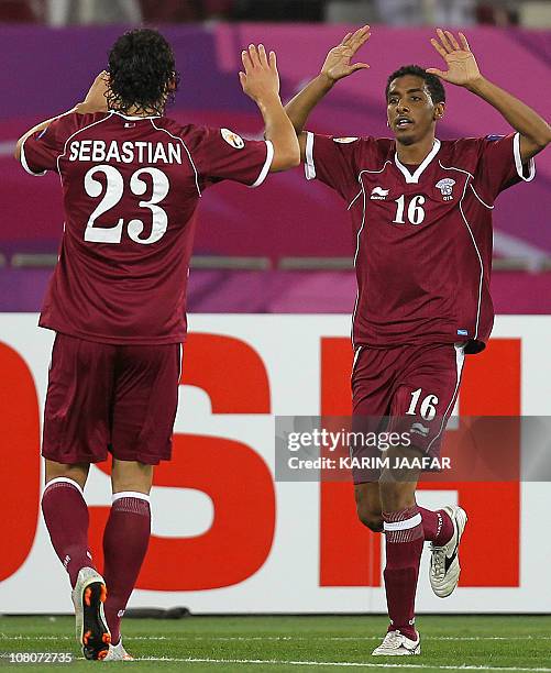 Qatar's forward Mohammed al-Sayed celebrates with teammate Sebastian Soria after scoring his team's second goal against Kuwait during their 2011...