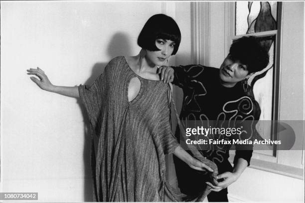 Fashion designer Vivian Chan Shaw and her daughter Claudia Vivian adjusts dresses modeled by her daughter. August 04, 1986. .