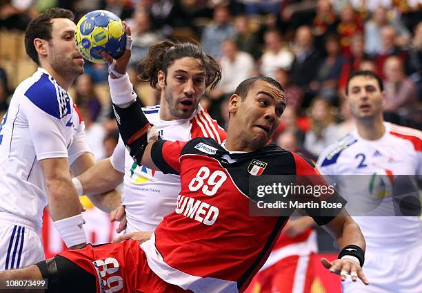 Mohamed Mamdouh of Egypt is challenged by Bertrand Gille of France during the Men's Handball World Championship Group A match between Egypt and...