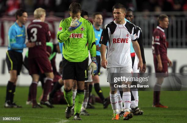 Michael Rensing and Lukas Podolski of Koeln are looking dejected after the Bundesliga match between 1. FC Kaiserslautern and 1. FC Koeln at...