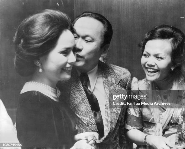 Madame Sukarno gets kiss from Mr. Masagung right Mrs. Rizel.Social pics from reception for Madame Sukarno at Hilton Hotel. April 18, 1975. .