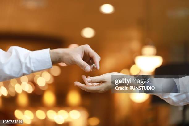 man giving engagement ring to woman - illuminated ring stock pictures, royalty-free photos & images