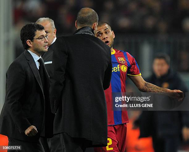 Barcelona's Brazilian defender Dani Alves chats with Barcelona's coach Josep Guardiola after he left the pitch for injuries during the Spanish league...