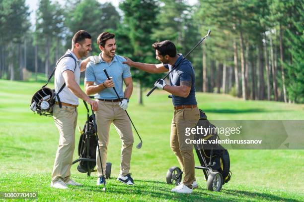 friends playing golf on a beautiful sunny day - golf stock pictures, royalty-free photos & images