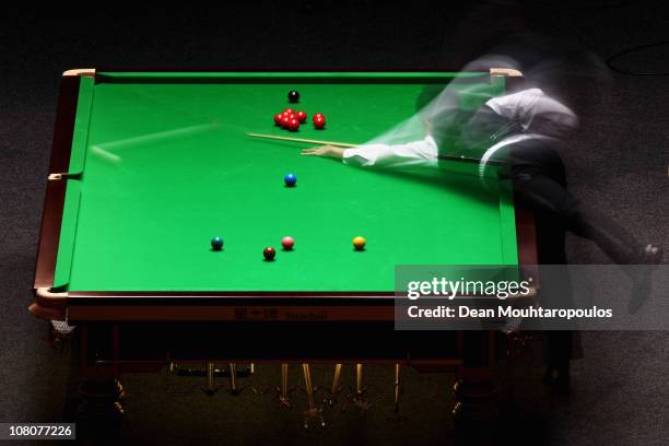 Marco Fu of Hong Kong in action against Ding Junhui of China in the Final of The Ladbrokesmobile Masters on Day 8 at Wembley Arena on January 16,...