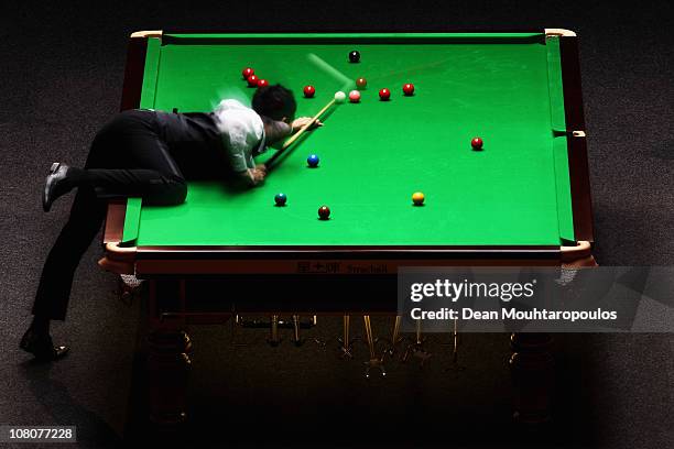 Marco Fu of Hong Kong in action against Ding Junhui of China in the Final of The Ladbrokesmobile Masters on Day 8 at Wembley Arena on January 16,...