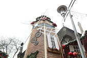 A mill stand at the Christmas Markets in the pedestrian Working Street next to Saint John the Baptist Church in Cardiff, United Kingdom