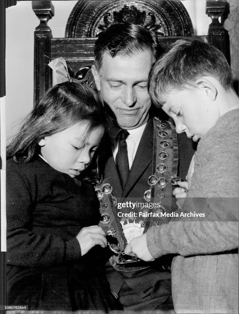 Woollahra sub normal children Penny, 6, and John, 7, admire the Mayoral chain worn by Alderman M.E. Lawrence, the Mayor of Woollahra, after gad met them yesty.Four of the Eastern Suburbs councils each will try and raise £8000, Woollahra council in a doo