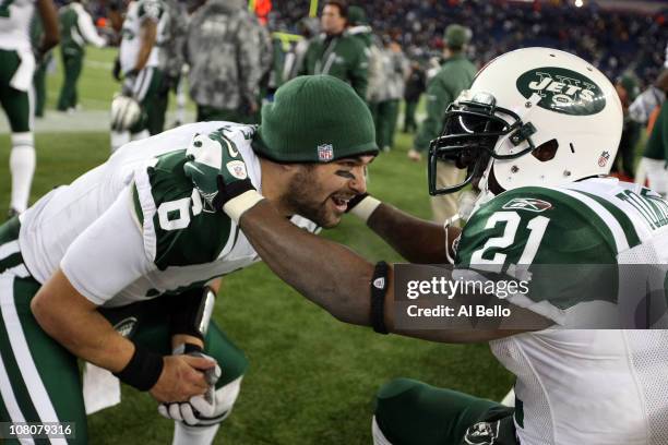 Mark Sanchez and LaDainian Tomlinson of the New York Jets celebrate after the Jets defeated the Patriots 28 to 21 in their 2011 AFC divisional...