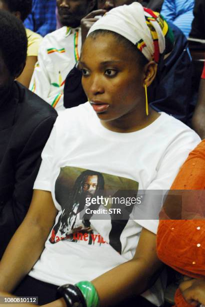 Lucky Dube's daughter Nonkululeko Zanele, wearing a shirt portraying slain music star Lucky Dube, sits before the handing down of judgement of Sifiso...