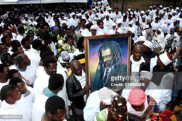 Shembe church of Nazareth worshippers and mourners carry a portrait, 28 October 2007, of South African reggae musician Lucky Dube, during his funeral...
