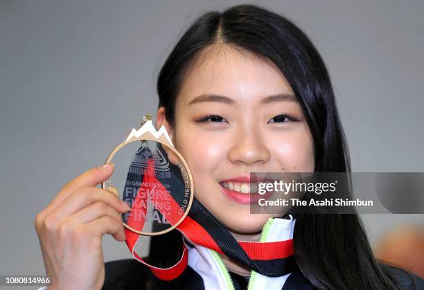 Figure skater Rika Kihira poses for photographs on arrival at Narita International Airport on December 11, 2018 in Narita, Chiba, Japan.