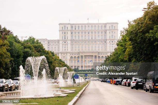 palace of the parliament and boulevard with fountains in bucharest, romania - bucharest stock pictures, royalty-free photos & images