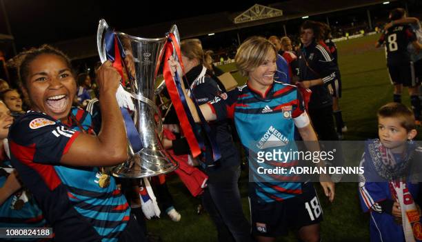 Olympique Lyonnais' Laura Georges and team Captain Sonia Bompastor celebrate with the trophy after winning the UEFA Women's Champions League final...