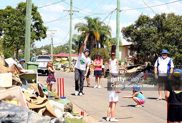 Australian cricketer Shane Watson joins in a game of street cricket with local residents in the suburb of Ipswich on January 17, 2011 in Brisbane,...