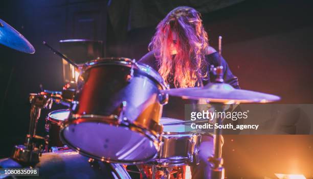 woman playing drums - drum stock pictures, royalty-free photos & images
