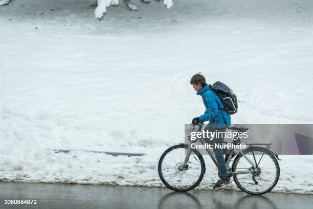Young biker during the snow storm. Many persons used the snow and the cold weather to sled. There were even people who skied or snowboarded. On 11...