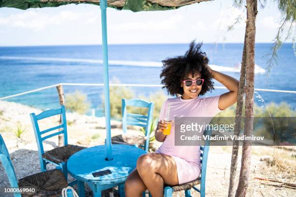 woman enjoying summer vacations and drinking juice - summer resort imagens e fotografias de stock