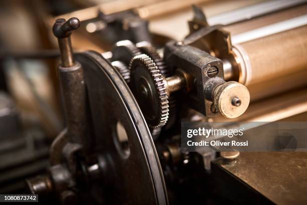 close-up of machinery in bookbinder's workshop - book binding stock pictures, royalty-free photos & images