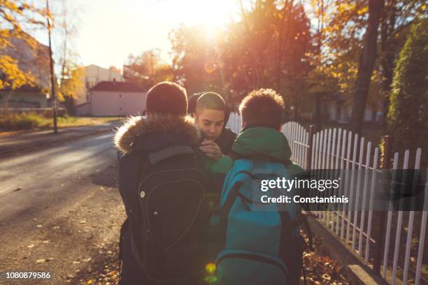 way to school. two angry teenage boys - aggression school stock pictures, royalty-free photos & images