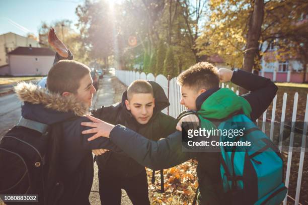 way to school. two angry teenage boys - aggression school stock pictures, royalty-free photos & images