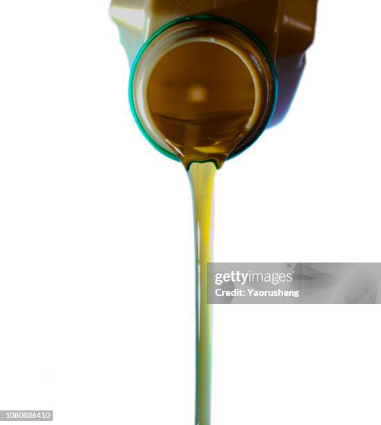 pouring oil to car engine. - canister stock pictures, royalty-free photos & images