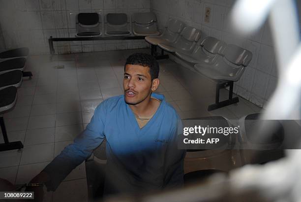 Hisham Mohammed Assem, a Yemeni accused of killing a Frenchman, sits behind the bars at the start of a court hearing in Sanaa on January 17 during...