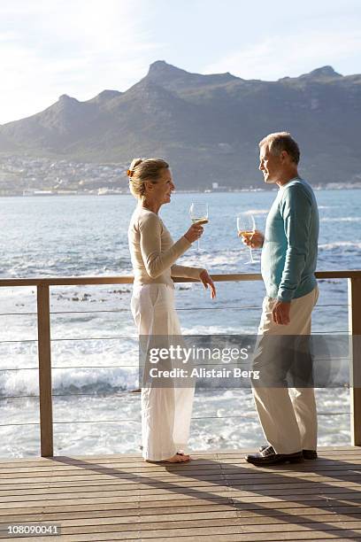 senior couple talking together - balustrade stock pictures, royalty-free photos & images
