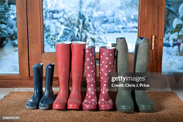 wellies on doormat - red boot stock pictures, royalty-free photos & images