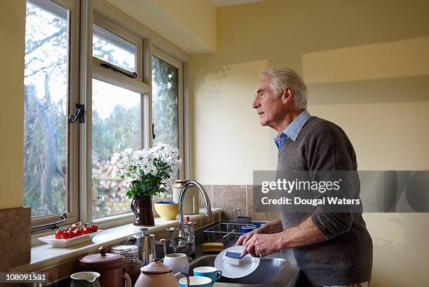 senior man washing up. - dirty dishes stock pictures, royalty-free photos & images