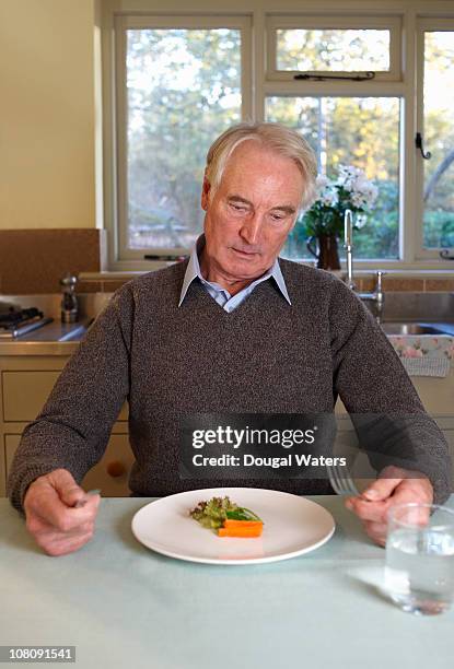 senior man with small salad on plate. - senior men eating stock pictures, royalty-free photos & images