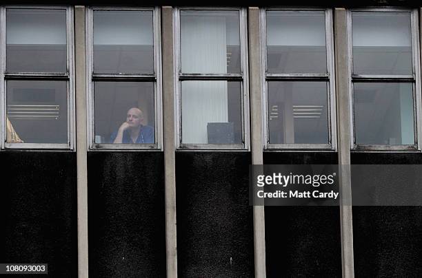 Man looks out of a window on the day officially dubbed as the most depressing day of the year or "blue Monday" on January 17, 2011 in Bristol,...