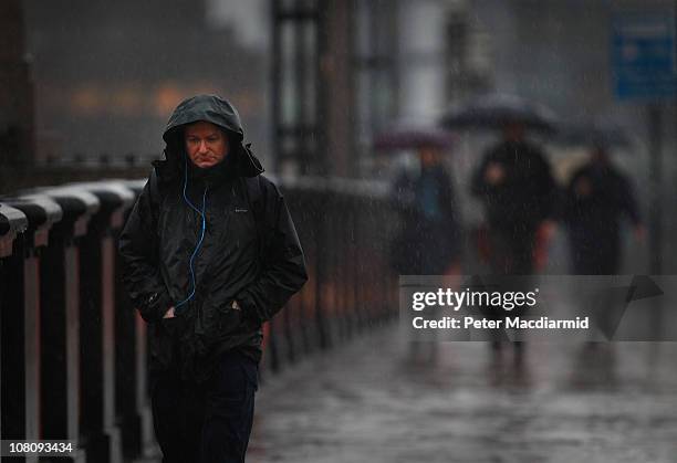 Man walks across Lambeth Bridge in the rain on "blue Monday" on January 17, 2011 in London, England. Psychologists say a number of factors including...