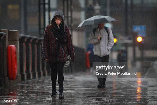 Woman walks across Lambeth Bridge in the rain on "blue Monday" on January 17, 2011 in London, England. Psychologists say a number of factors...