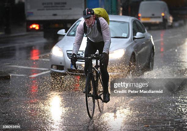 Cyclist splashes through a puddle near Parliament on "blue Monday" on January 17, 2011 in London, England. Psychologists say a number of factors...