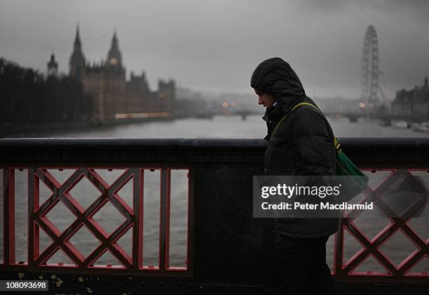 Man walks across Lambeth Bridge in the rain on "blue Monday" on January 17, 2011 in London, England. Psychologists say a number of factors including...