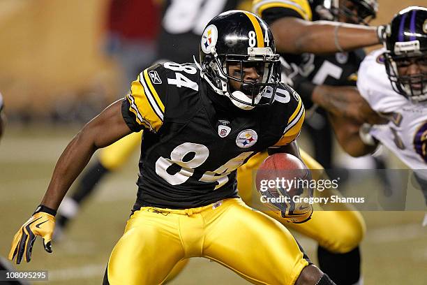 Wide receiver Antonio Brown of the Pittsburgh Steelers runs with the ball after a catch against the Baltimore Ravens in the AFC Divisional Playoff...