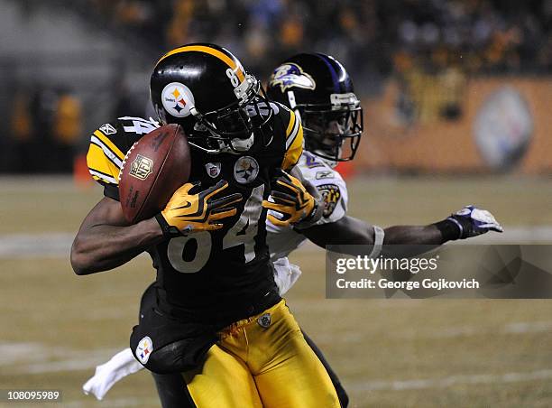 Wide receiver Antonio Brown of the Pittsburgh Steelers catches a 58-yard pass against cornerback Lardarius Webb of the Baltimore Ravens during an AFC...