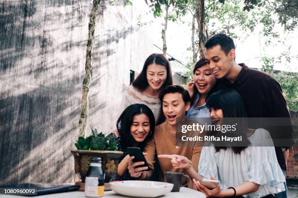 group of young asian people with smartphone - malaysian stock pictures, royalty-free photos & images