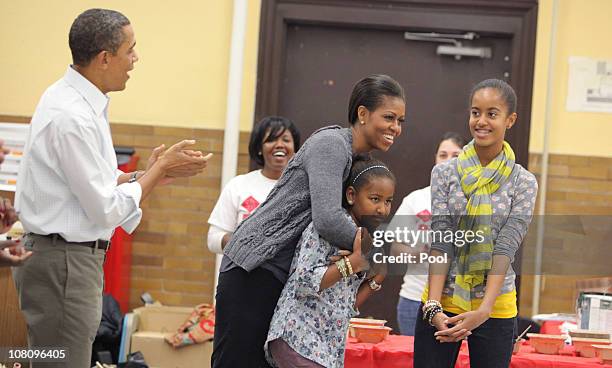 President Barack Obama and daughters Malia and Sasha sing "Happy Birthday" to first lady Michelle Obama on her birthday January 17, 2011 in...