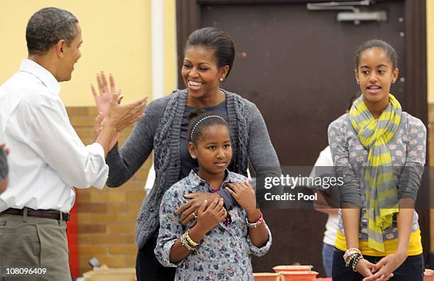 President Barack Obama and daughters Malia and Sasha sing "Happy Birthday" to first lady Michelle Obama on her birthday January 17, 2011 in...