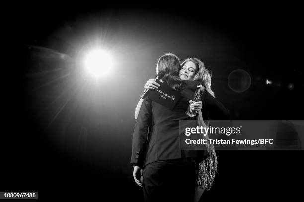 Cyrill Gutsch for Parley For The Oceans hugs award presenter Doutzen Kroes after receiving the Special Recognition Award for Innovation during The...