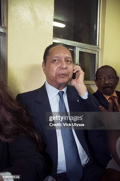 Jean-Claude Duvalier, the former Haitian leader speaks on his phone upon arriving at the airport on January 16, 2011 in Port-au-Prince, Haiti....