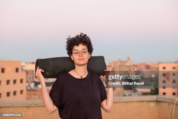 young woman doing yoga on a rooftop