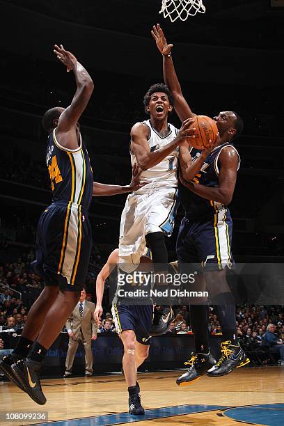 Nick Young of the Washington Wizards shoots against Paul Millsap and Al Jefferson of the Utah Jazz at the Verizon Center on January 17, 2011 in...
