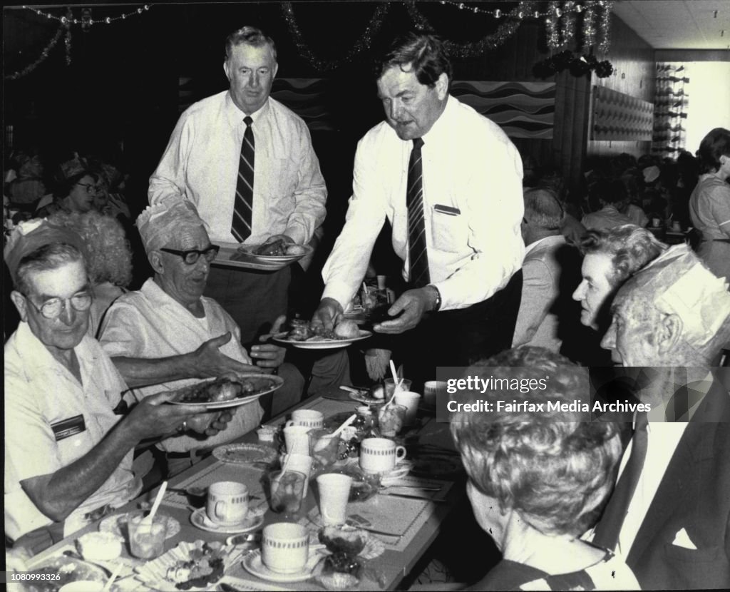 The Annual Woolworths head office Christmas party & dinner for 600 pensioners of Sydney held in Woolworths 2nd floor Cagetteria, George & Park Sts. Sydney.Woolworths managing director, Harry Watts, Serving Guests a the Christmas party.