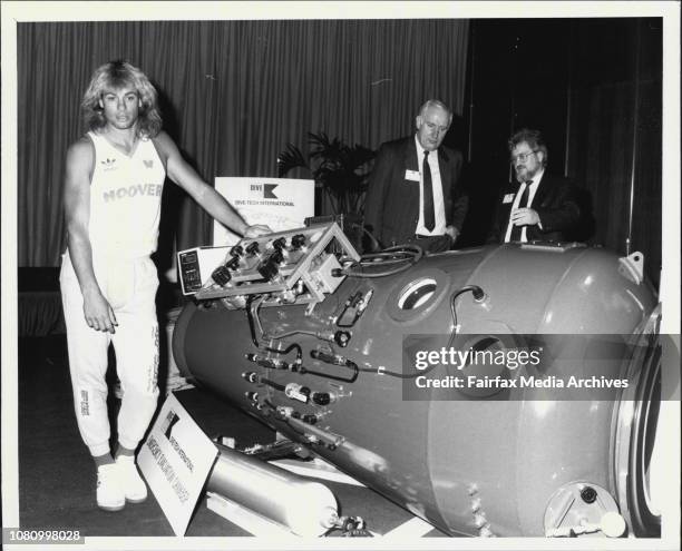 Sydney Swans full forward Warwick Capper with the new &amp; 100,000 Divetech International decompression chamber at the Sydney Hilton. March 2, 1987....