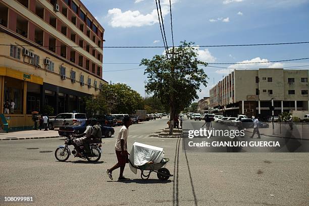 Coal brings boom to Mozambique's Tete cityPhoto dated on November 10, 2010 shows a Mozambican man pushing his cart in the Tete central businness...