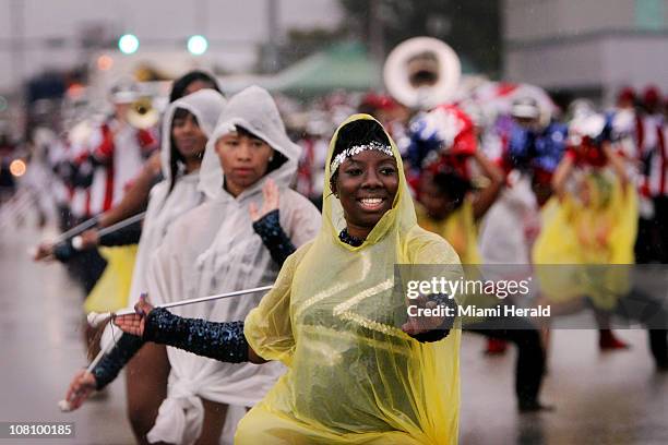 Kiana Owens a majorette with the American High School Mighty Marching Patriots, smiles through the rainy routine during the annual Dr. Martin Luther...